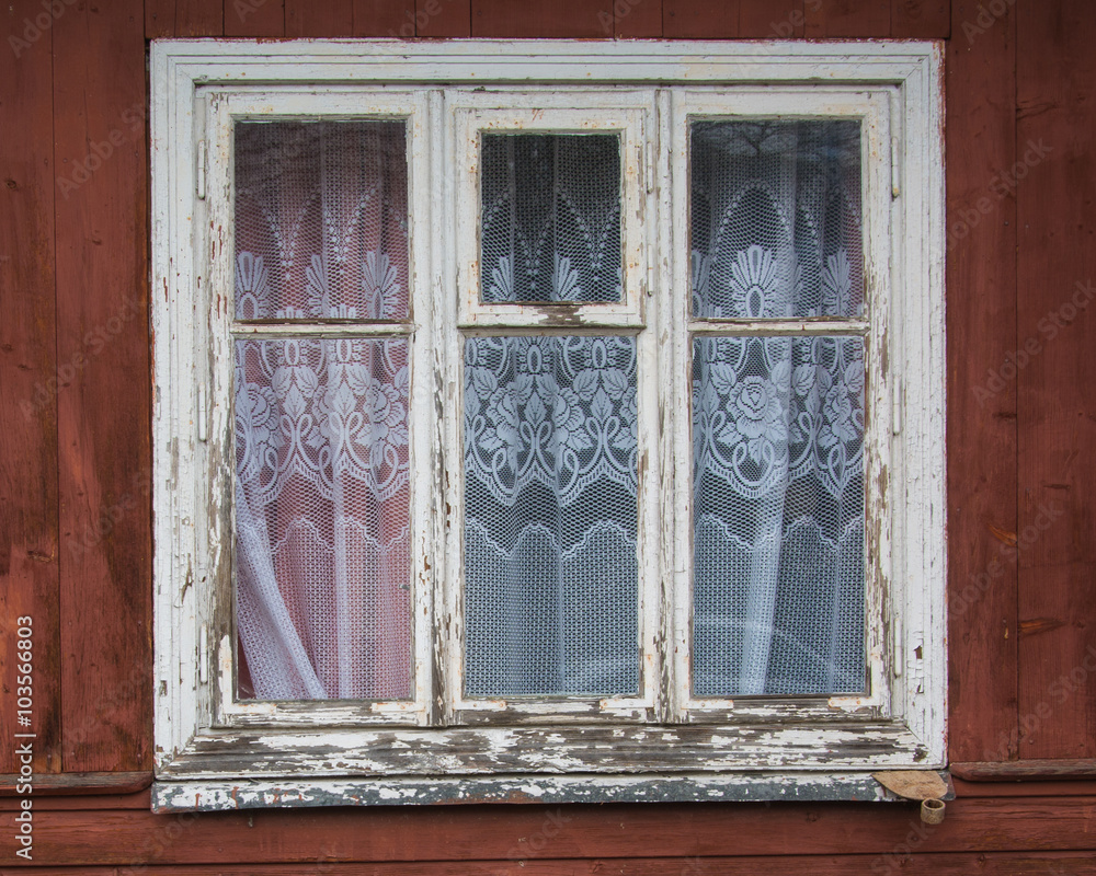 Fototapeta premium closed old window on a aged wooden wall