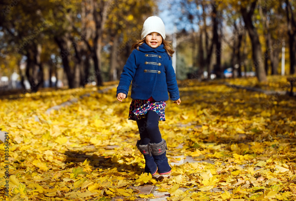Little girl playing in autumn park Little girl playing in autumn park