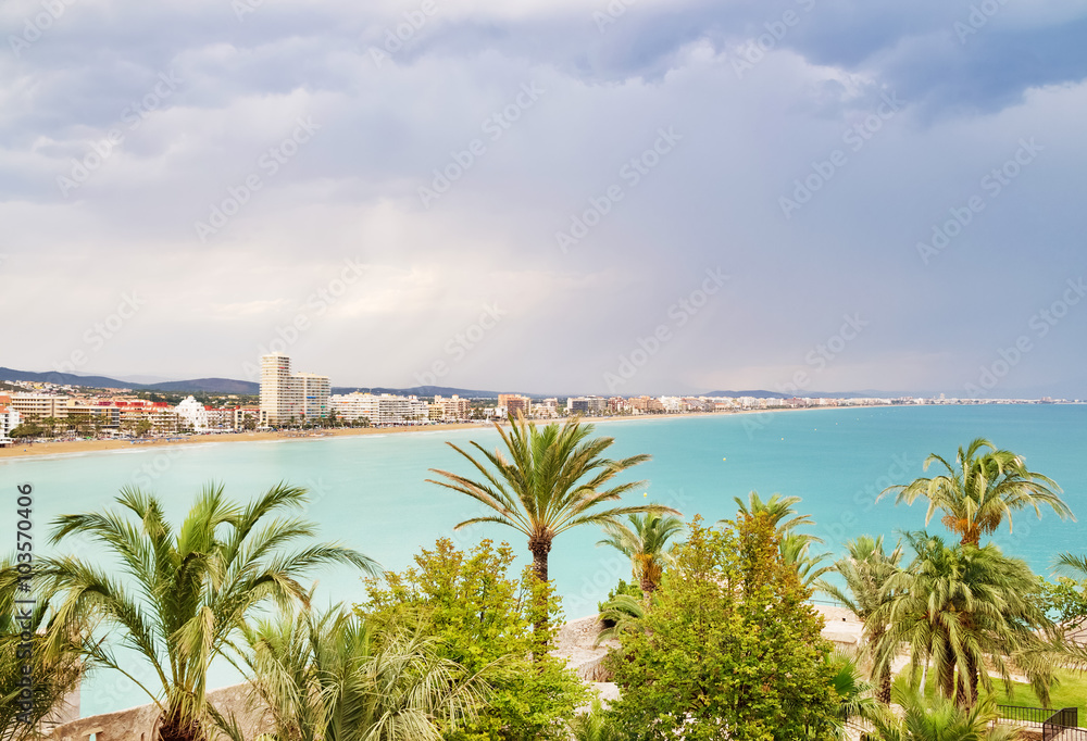 View over the palm trees and coastline of Peniscola, Spain
