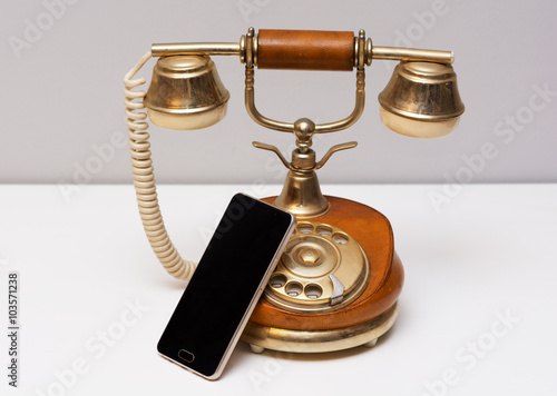 Old vintage phone and new modern smartphone