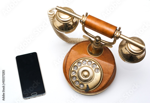 Old vintage phone and new modern smartphone
