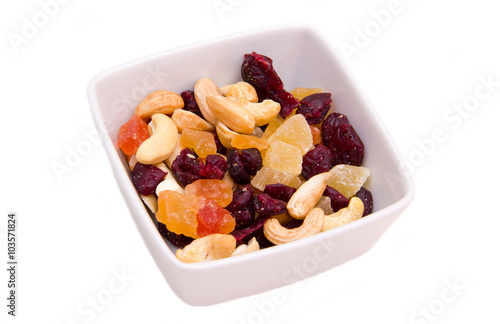 Dried fruits on square bowl on a white background