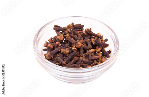 cloves on a glass bowl on white background