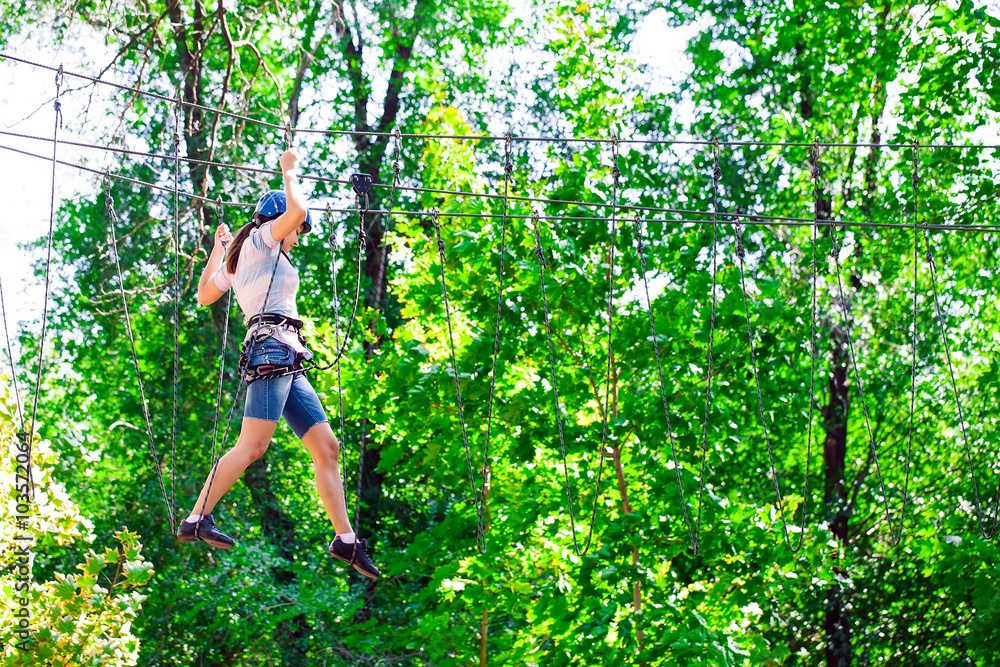 adventure climbing high wire park - people on course in mountain adventure climbing high wire park - people on course in mountain