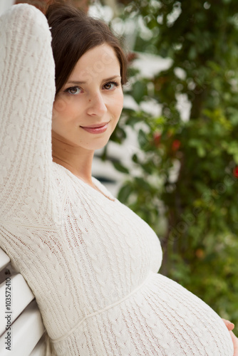 beautiful pregnangt woman sitting in garden