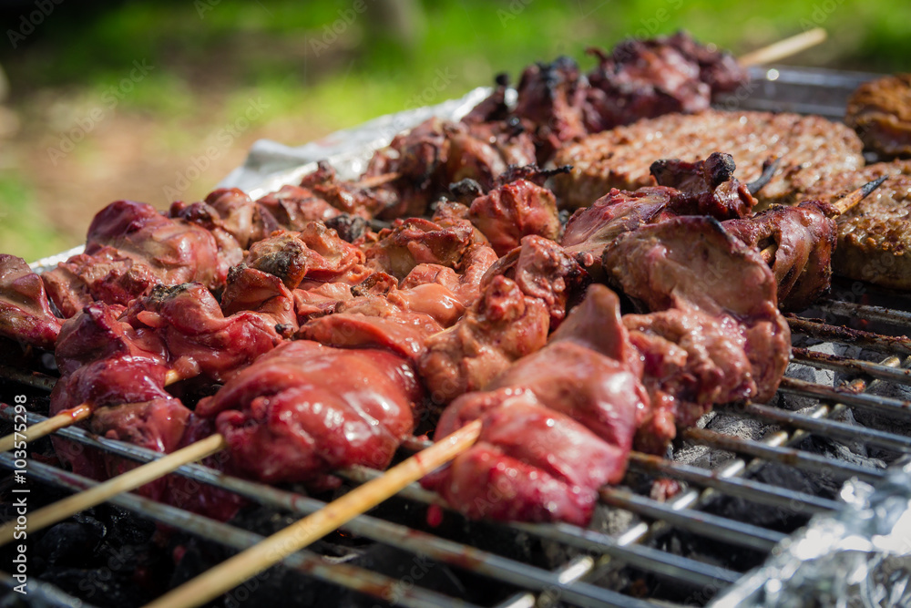 Different types of meat are cooked on the grill - close up