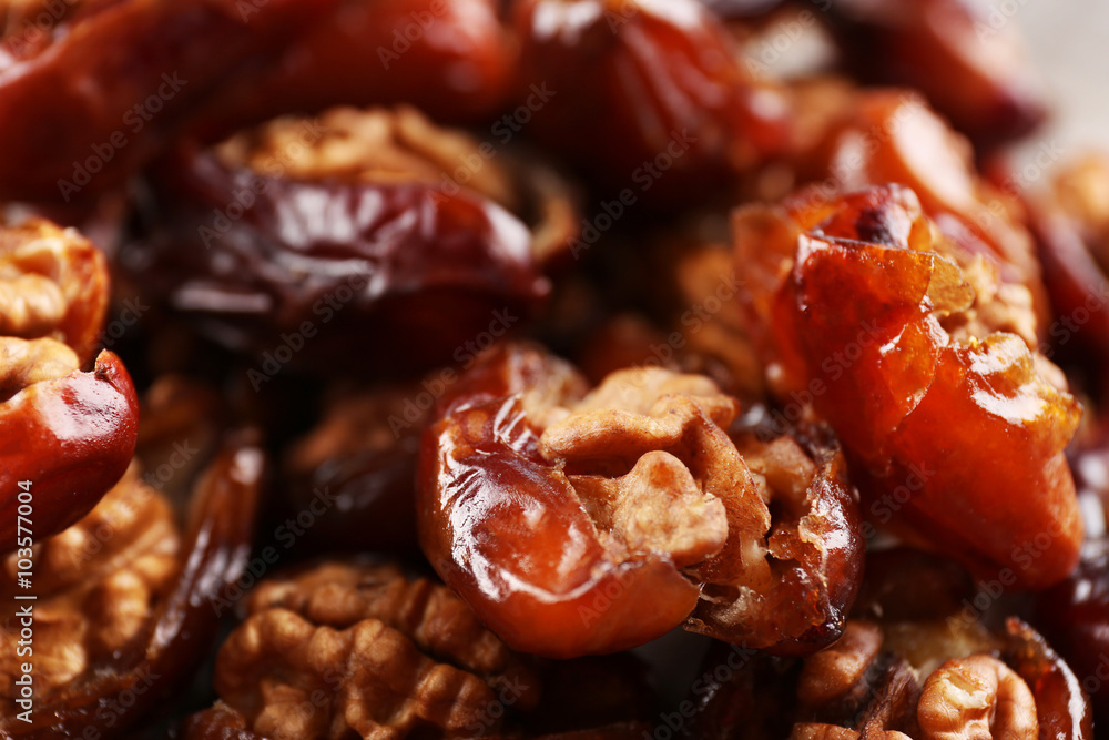 Walnut and date fruit on wooden table, close-up Walnut and date fruit on wooden table, close-up