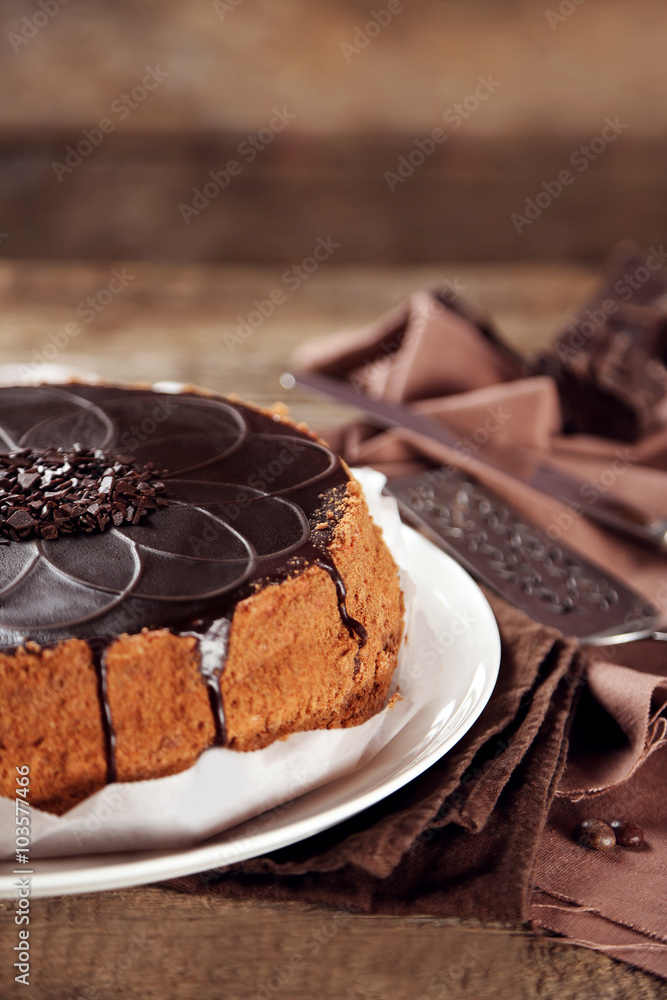Tasty chocolate cake on wooden background