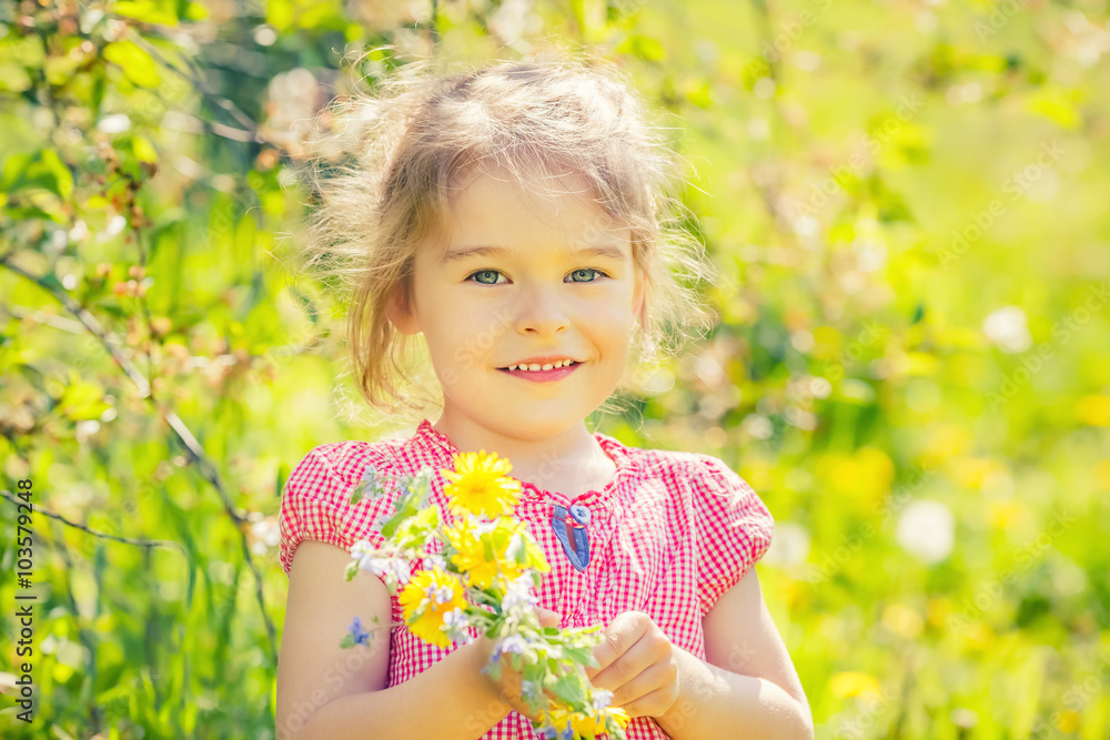 Happy little girl playing with bouquet in sunny park Happy little girl playing with bouquet in sunny park