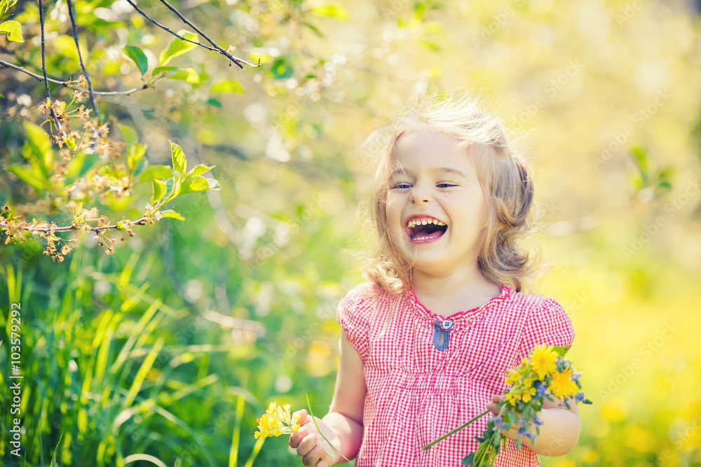 Happy little girl playing with bouquet in sunny park Happy little girl playing with bouquet in sunny park