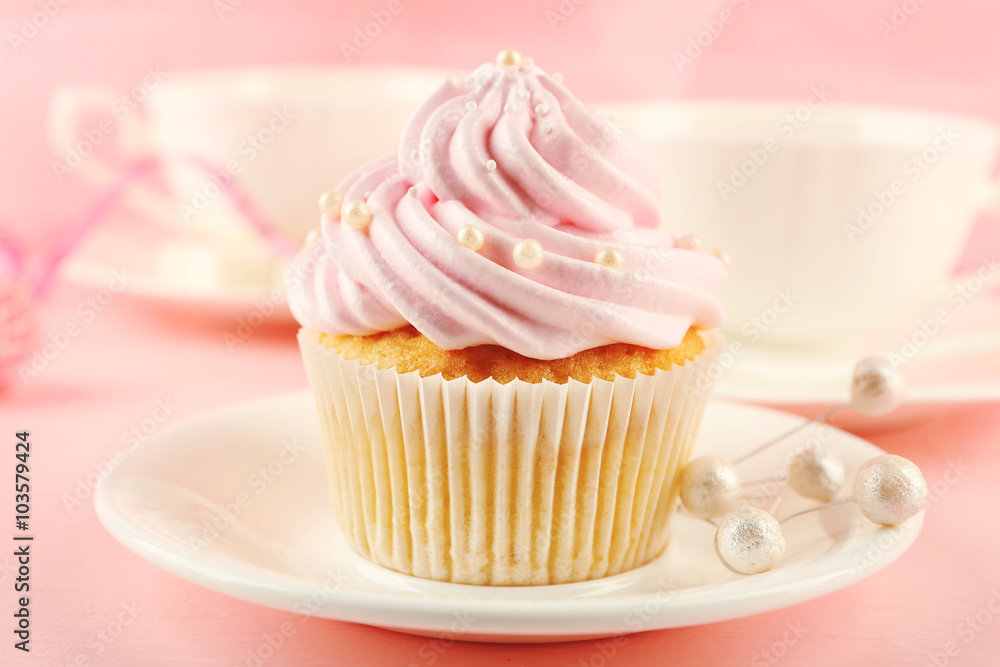 Tasty cupcakes with tea set and decorations, closeup Tasty cupcakes with tea set and decorations, closeup
