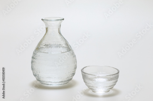 Sake cup and bottle on white background