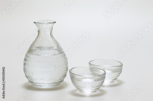 Sake cup and bottle on white background