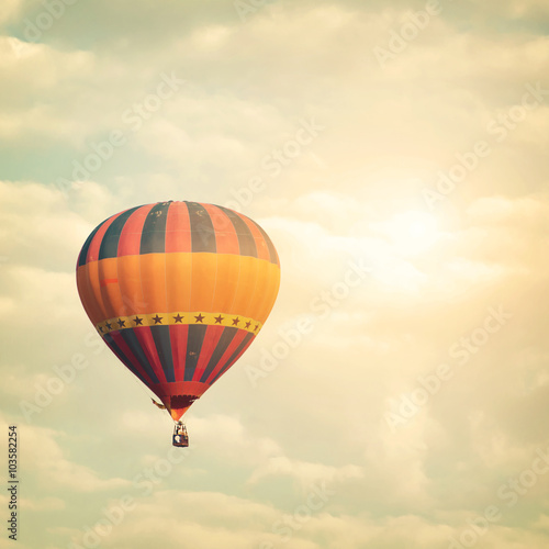 Hot air balloon on sun sky with cloud, vintage and retro filter effect style