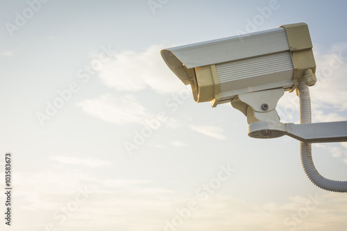 CCTV Security camera video surveillance on sky background