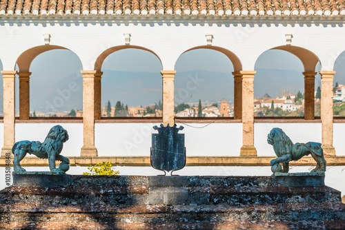 Arch of white building in the Generalife palace with aerial view at Granada. Spain