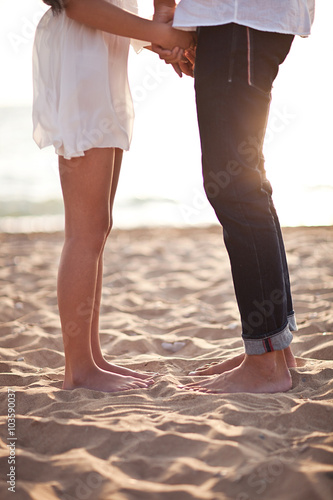 Couple's legs on the sand © Anastasiia Krivenok