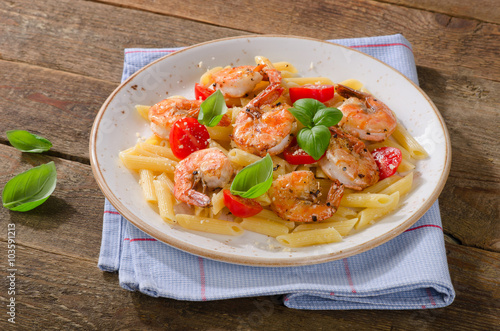 Penne pasta with shrimp, tomatoes and herbs.