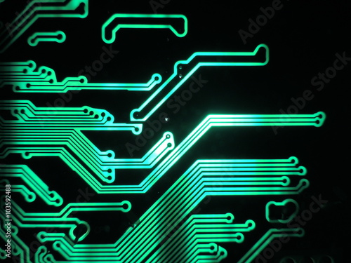 Green glowing patterns of a printed circuit board