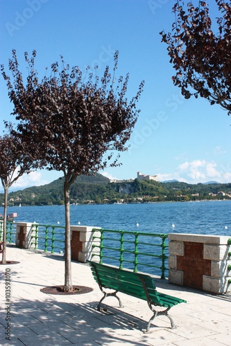 Park Bench by Lake Maggiore in Arona with view to Angera, Lombardy Italy