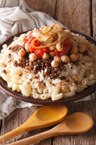 Vegetarian food: kushari of rice, pasta, chickpeas and lentils close up 
