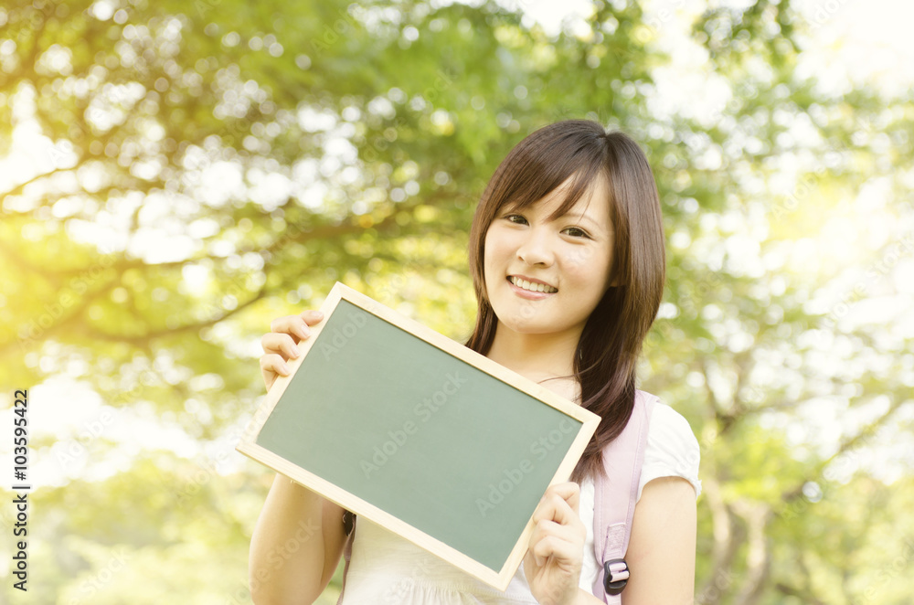 Young Asian college girl student showing blank chalkboard Young Asian college girl student showing blank chalkboard