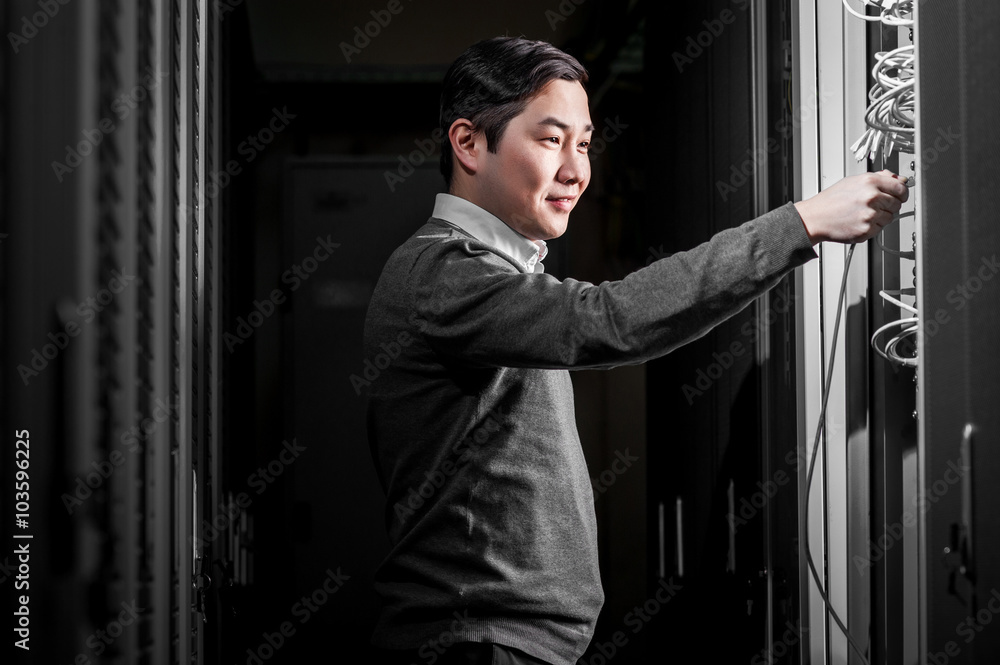 Young engineer businessman in server room Young engineer businessman in server room