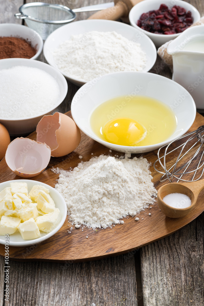 prepared baking ingredients on wooden table, vertical prepared baking ingredients on wooden table, vertical