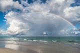 Ocean rainbow with stunning cloudscape