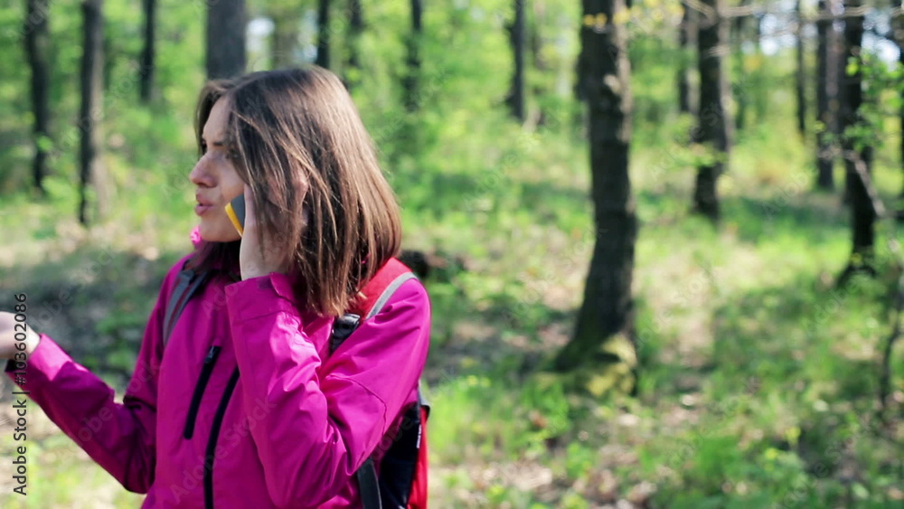 A lost woman talking on cellphone and looking for direction in the forest
A lost woman talking on cellphone and looking for direction in the forest