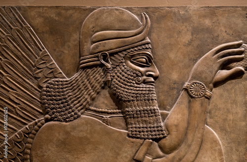 Ancient relief of an assyrian god photo