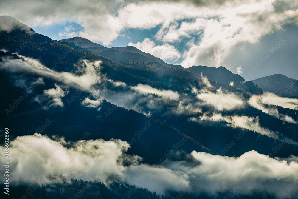 Amazing view of Slovenian mountains near Bled, Slovenia. Sunshine behind foggy mountains after a rainy day.