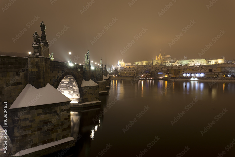 Night romantic snowy Prague gothic Castle with Charles Bridge, Czech republic Night romantic snowy Prague gothic Castle with Charles Bridge, Czech republic