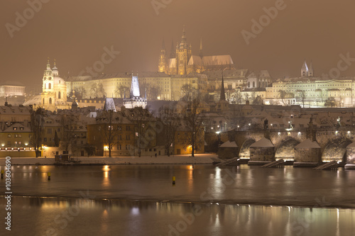 Night romantic snowy Prague gothic Castle with Charles Bridge, Czech republic