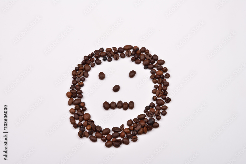 Picture shape face made of coffee beans on white background. Mor Picture shape face made of coffee beans on white background. Mor