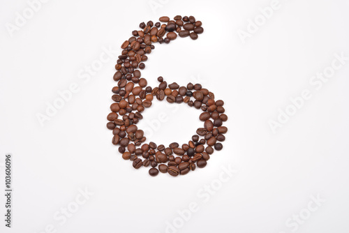 Number six from coffee beans isolated on white background. Love