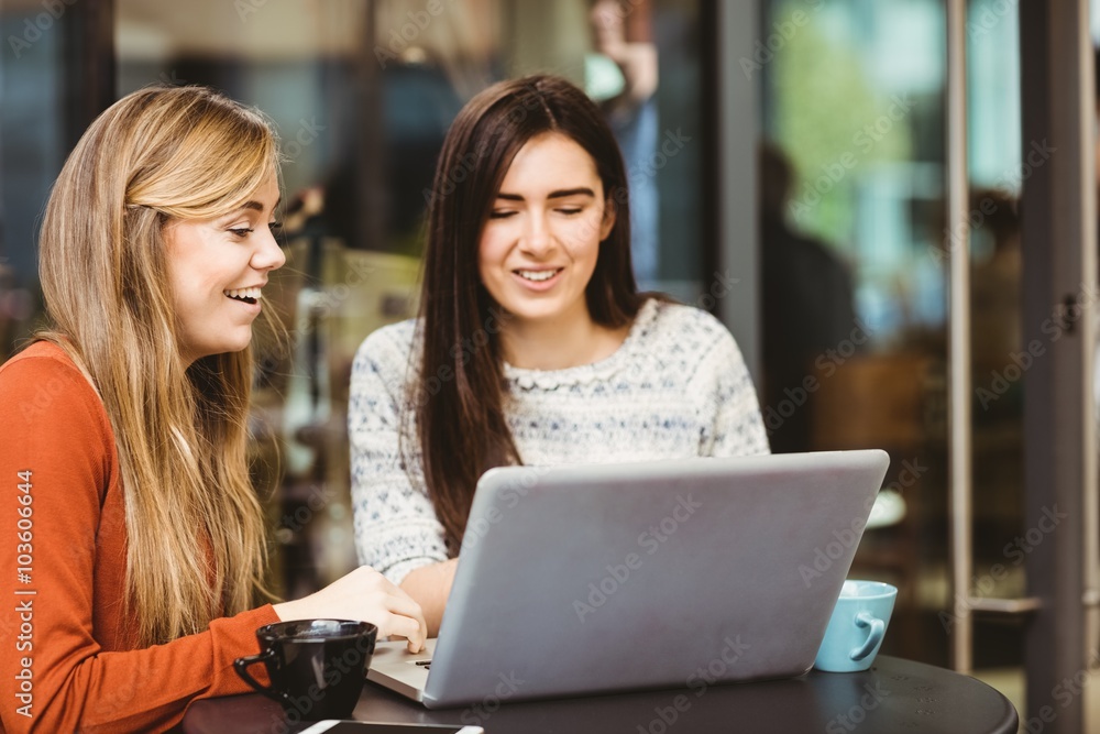 Friends using laptop together