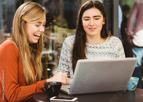 Friends using laptop together