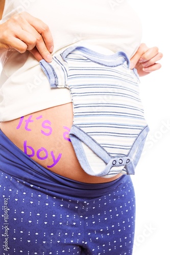 Pregnant woman holding pyjamas over her belly