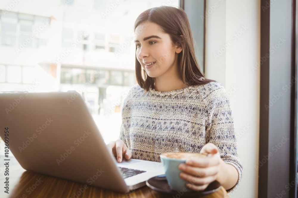 Pretty brunette using laptop