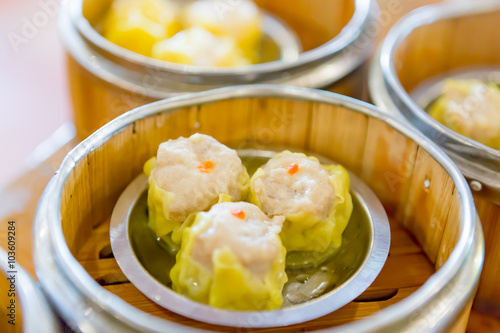 Siu Mai / Dim sum - Chinese steamed pork dumplings in bamboo ste photo