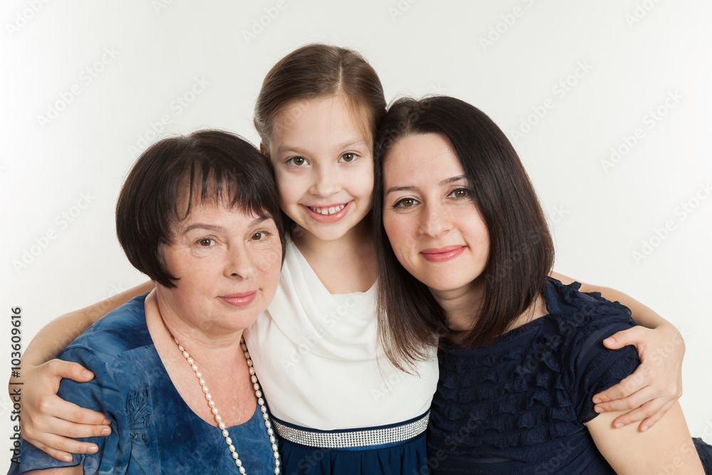 The granddaughter embraces the grandmother and mother The granddaughter embraces the grandmother and mother