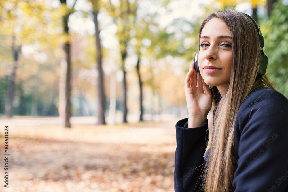 Close up Portrait of young blonde woman relaxing listening to music with headphones. Close up Portrait of young blonde woman relaxing listening to music with headphones.