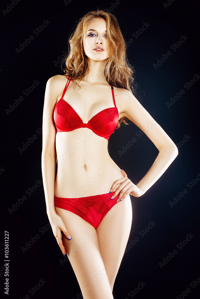 Sexy beautiful smiling young blonde model with big tits. in sexy red  lingerie. in the studio on a black background Photos | Adobe Stock