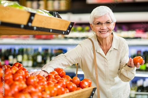 Senior woman choosing her tomatoes