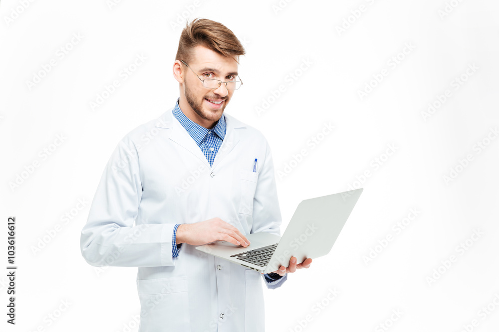 Happy male doctor using laptop computer Happy male doctor using laptop computer