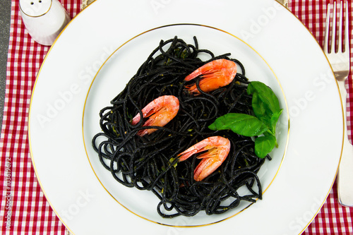 Black Spaghetti with Cuttlefish Ink, Prawns and Basil. Mediterra photo