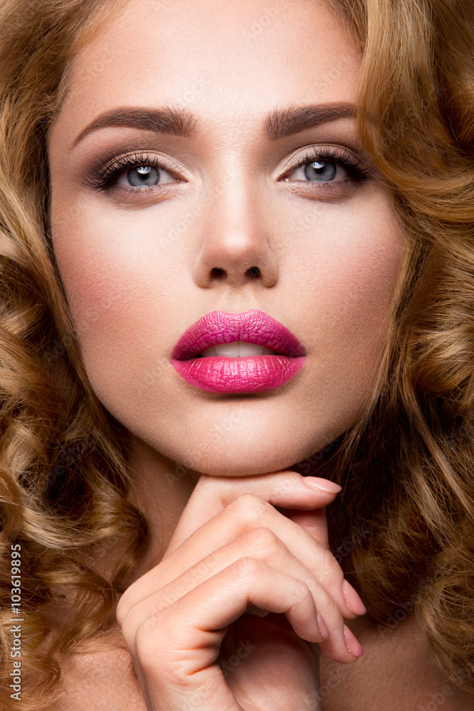 Glamour portrait of beautiful girl model with makeup and romantic wavy hairstyle. Fashion shiny highlighter on skin, sexy gloss lips make-up and dark eyebrows. Glamour portrait of beautiful girl model with makeup and romantic wavy hairstyle. Fashion shiny highlighter on skin, sexy gloss lips make-up and dark eyebrows.