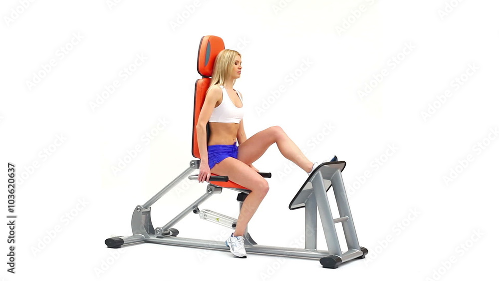 Woman on orange hydraulic exerciser Woman on orange hydraulic exerciser