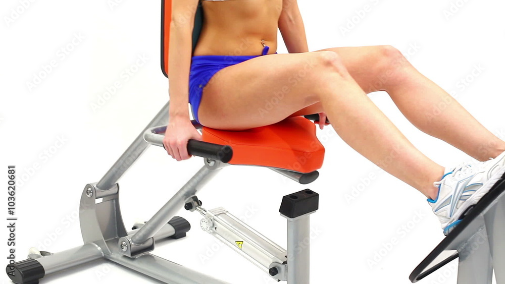 Fragment of woman on hydraulic exerciser Fragment of woman on hydraulic exerciser